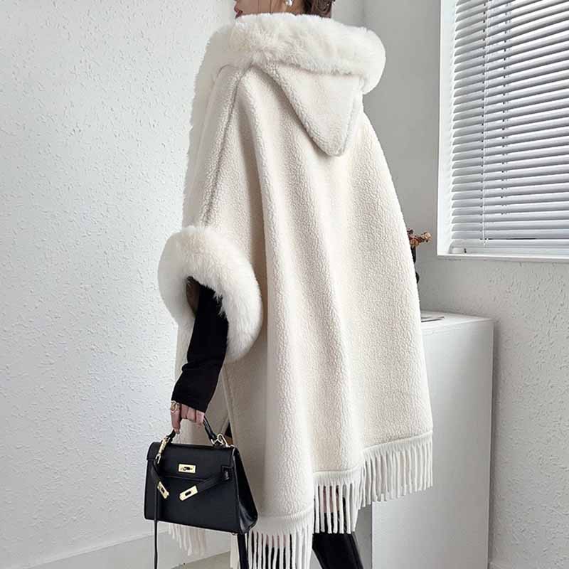 Elegant women's fur collar poncho in cream with fringe details, perfect for stylish layering