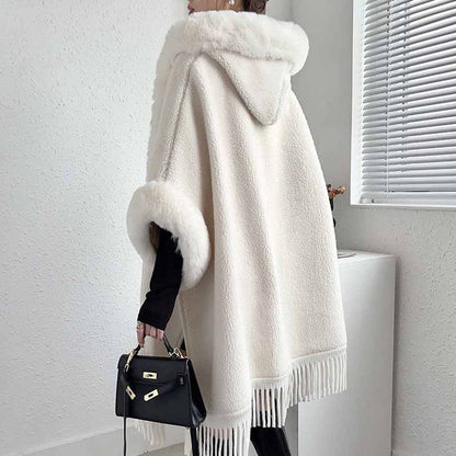 Elegant women's fur collar poncho in cream with fringe details, perfect for stylish layering