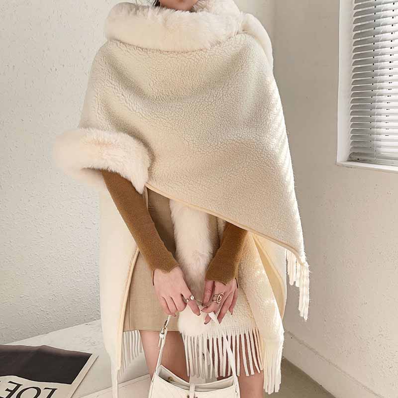 Elegant women's fur collar poncho by S&DCo in cream with soft texture and fringe details