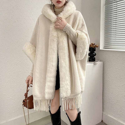 Women's fur collar poncho in cream with fringe detailing, perfect for stylish warmth