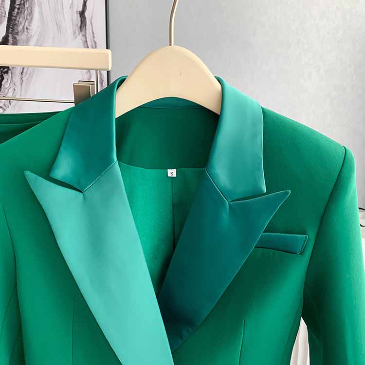 Close-up of a women's green pantsuit formal featuring a stylish satin lapel