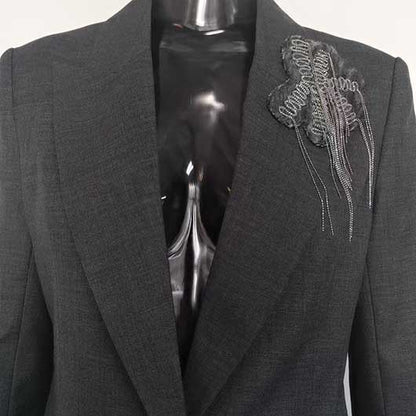 Close-up of SD Dresscode women's grey tailored pantsuit with stylish floral detail on lapel