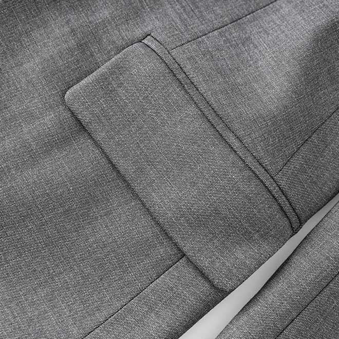 Close-up of women's grey tailored pantsuit showcasing premium fabric and detailed stitching