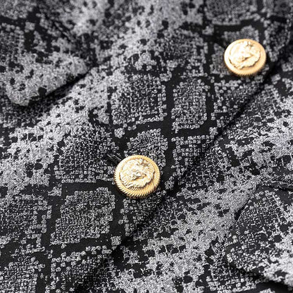 Close-up of a women's jacquard blazer black featuring textured fabric and gold buttons