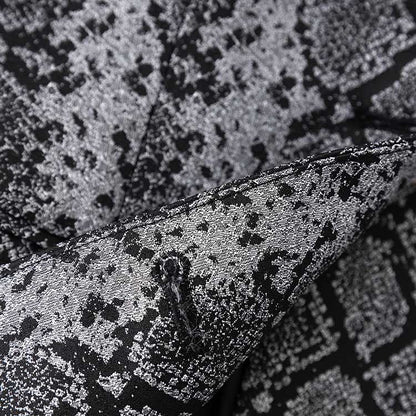 Close-up of women's jacquard blazer black showcasing intricate fabric texture and design