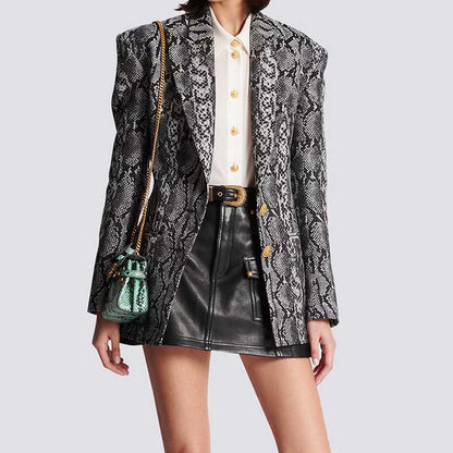 Stylish women's jacquard blazer black featuring a snakeskin pattern, paired with a white shirt and leather skirt