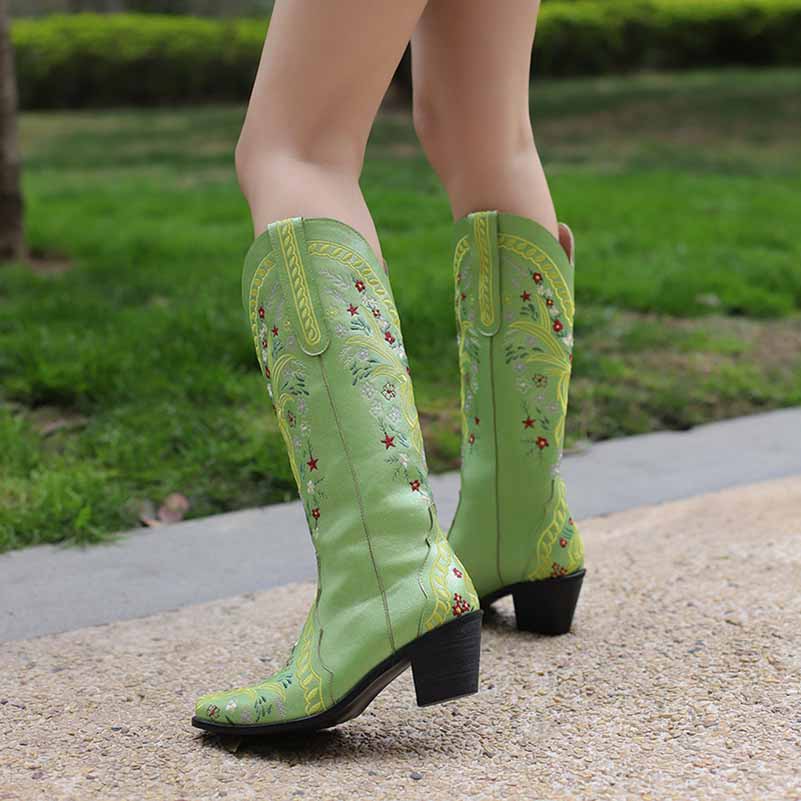 Stylish women's knee length cowgirl boots in green with floral embroidery and a chunky heel