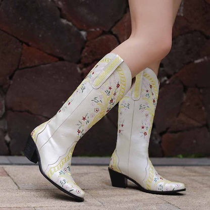 Stylish women's knee length cowgirl boots in white with floral embroidery and stacked heels