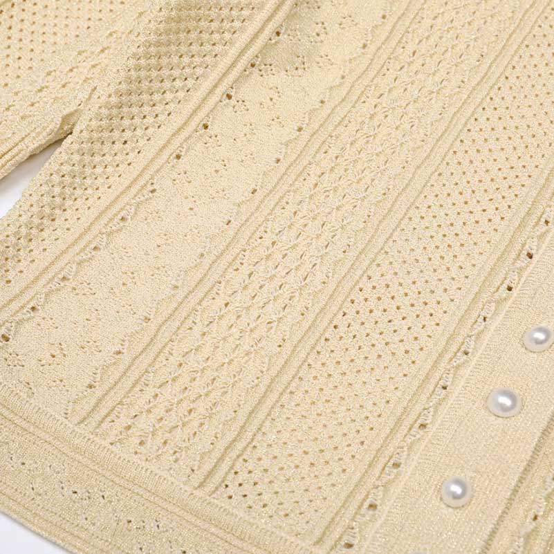 Elegant women's knit long skirt suit in cream with intricate textured design and pearl buttons