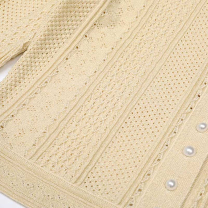 Elegant women's knit long skirt suit in cream with intricate textured design and pearl buttons