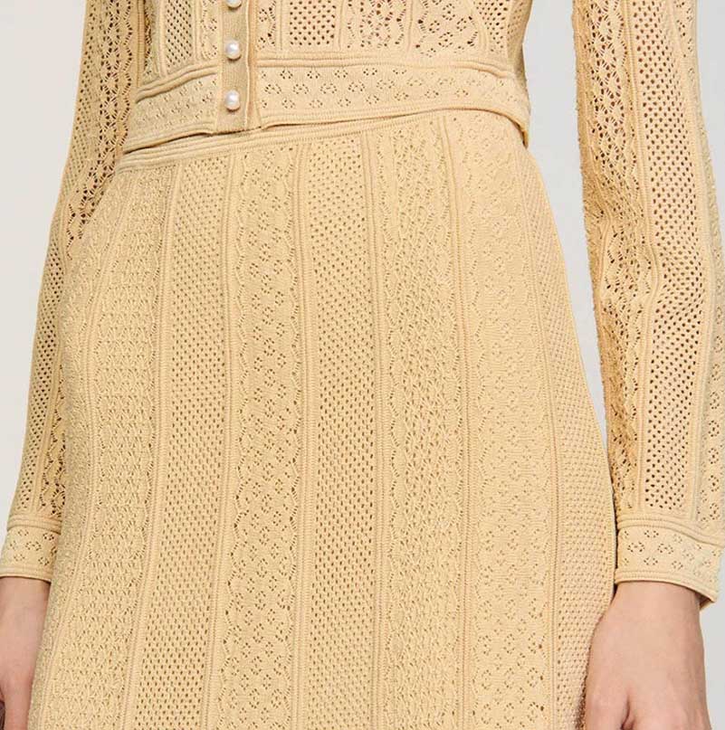 Stylish women's knit long skirt suit in beige featuring intricate knit patterns and elegant button details