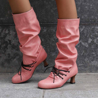 Stylish women's lace-up high shaft boots in pink, featuring a slouchy design and comfortable heels