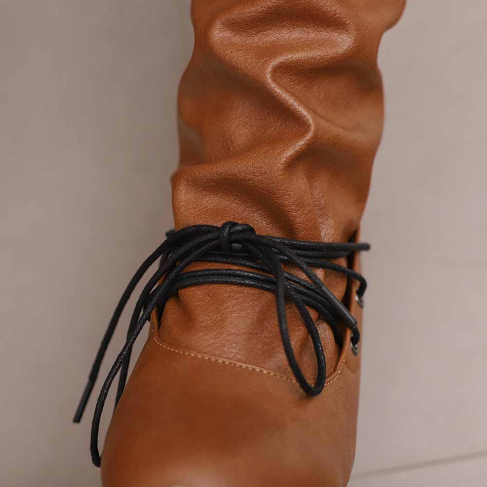 Women's lace-up high shaft boots in brown with stylish lacing detail and soft texture