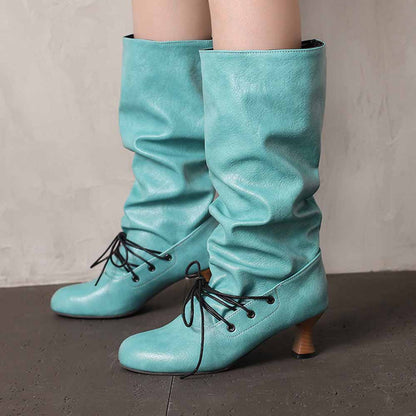 Women's lace-up high shaft boots in teal with slouchy design and low heel for a stylish look