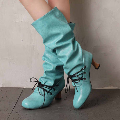 Stylish women's lace-up high shaft boots in turquoise with a slouchy design and heel