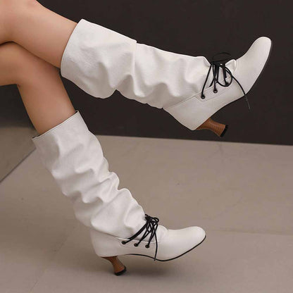 Stylish women's lace-up high shaft boots in white with a chic slouch design and heel