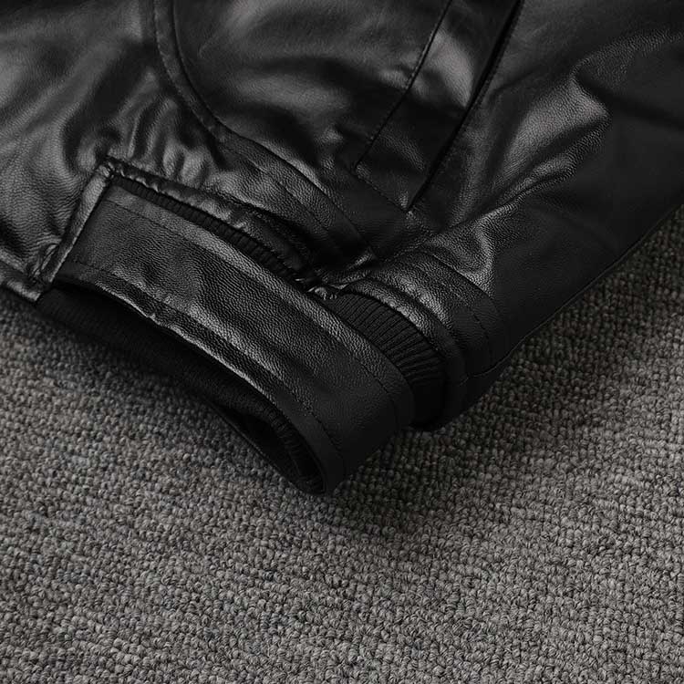 Close-up of women's leather effect jacket with shearling collar highlighting the cuff detail