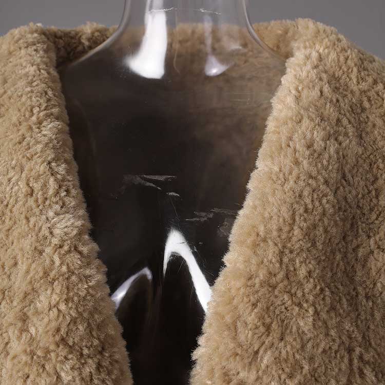 Close-up of a soft shearling collar on a women's leather effect jacket with shearling collar