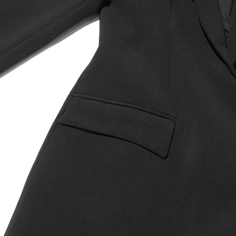 Close-up of a women's maxi blazer coat in black with sleek pocket detailing
