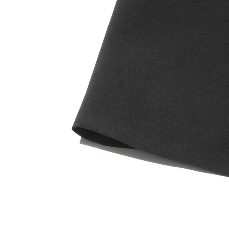 Close-up of black women's maxi blazer coat fabric showcasing its smooth texture and elegant design