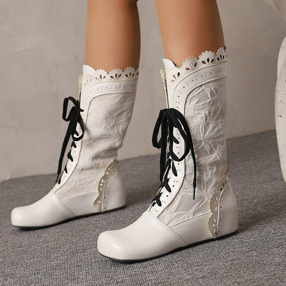 Women's mid-calf lace up wedge boots in white with decorative detailing and stylish lacing