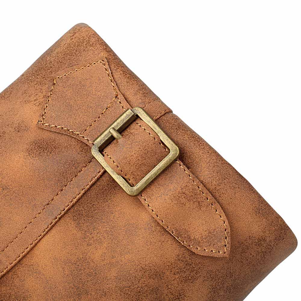 Close-up of brown women's mid-calf low heel boots with stylish buckle detailing