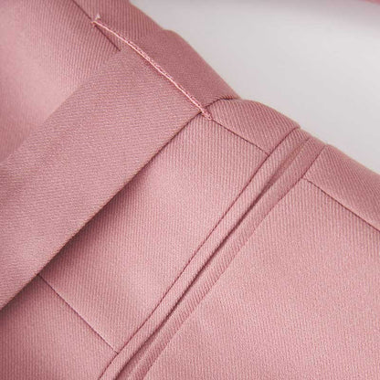 Close-up of a women's pink pantsuit for formal events, featuring tailored seams and elegant fabric texture