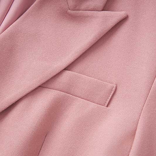 Close-up of SD Dresscode women's pink pantsuit for formal events showcasing soft fabric and tailored design.