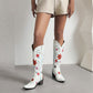 Stylish women's retro floral cowboy boots in white with colorful floral designs and a block heel