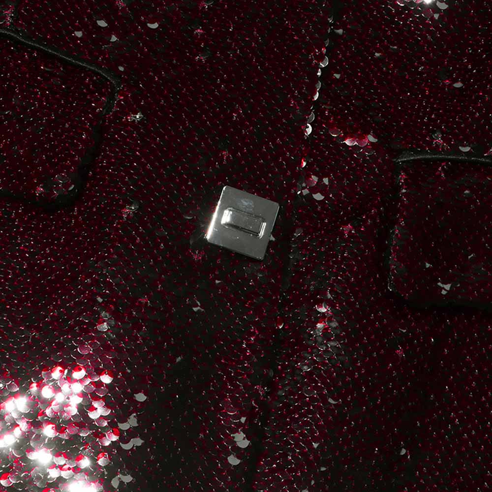 Close-up of sd-hk women's sequin blazer with a shiny, textured fabric and silver button detail