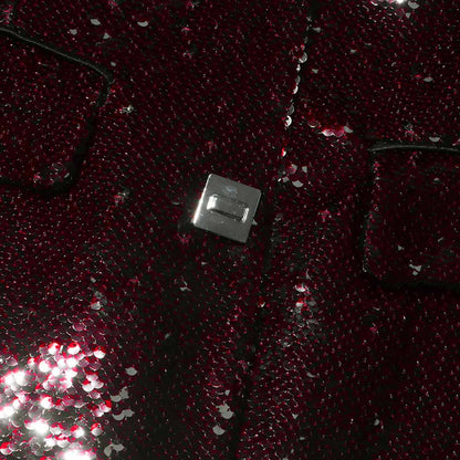 Close-up of sd-hk women's sequin blazer with a shiny, textured fabric and silver button detail