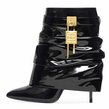 Stylish women's shark lock stiletto ankle boots in glossy black with gold accents for a chic look