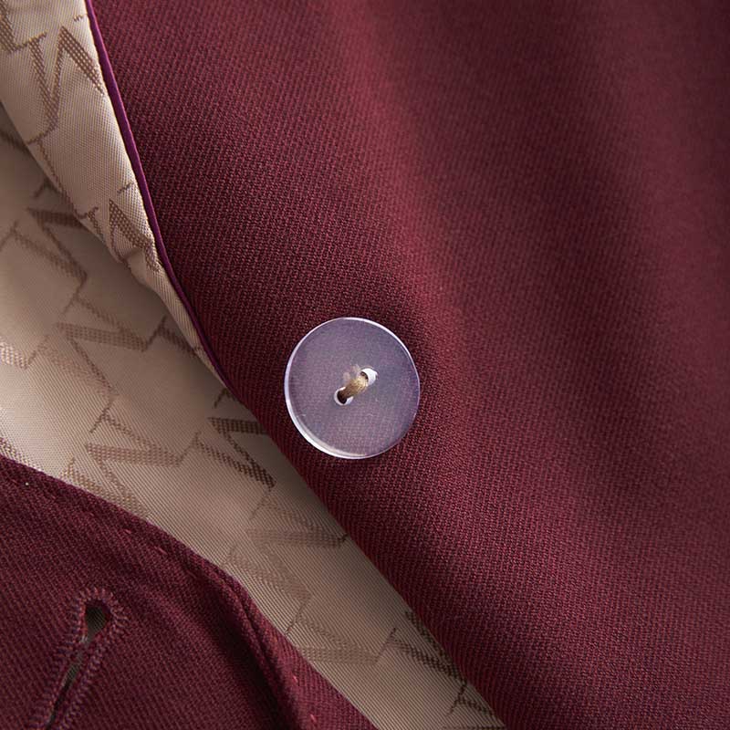 Close-up of a women's straight-leg pants suit by SD Dresscode featuring a maroon fabric and button detail