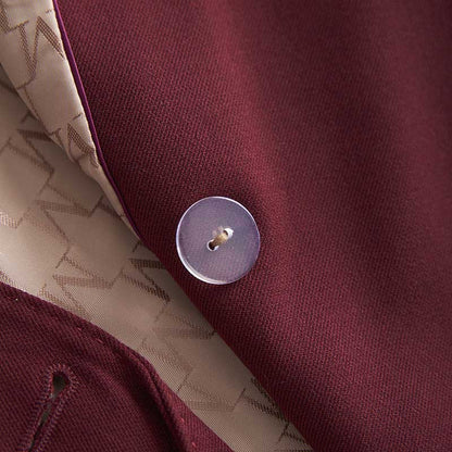 Close-up of a women's straight-leg pants suit by SD Dresscode featuring a maroon fabric and button detail