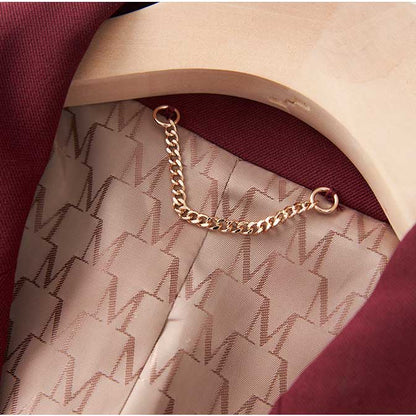 Close-up of women's straight-leg pants suit detailing with chain hanger in rich maroon color