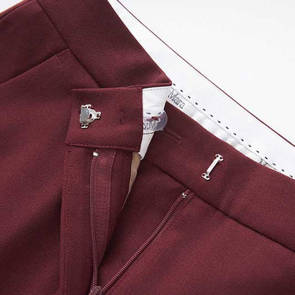 Close-up of burgundy women's straight-leg pants suit featuring sleek waistband and elegant finish