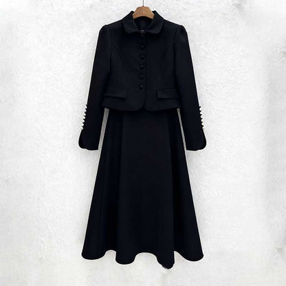 Elegant women's two piece skirt suit in black with a tailored jacket and flowing skirt