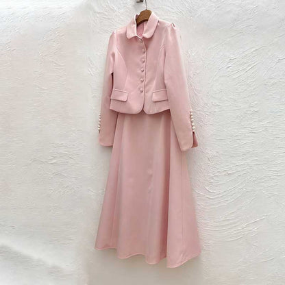 Pink women's two piece skirt suit featuring a stylish jacket and flowing skirt for elegant occasions