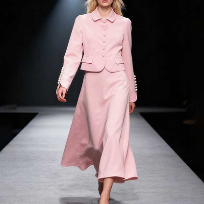Elegant women's two piece skirt suit in pink featuring a tailored jacket and flowy skirt