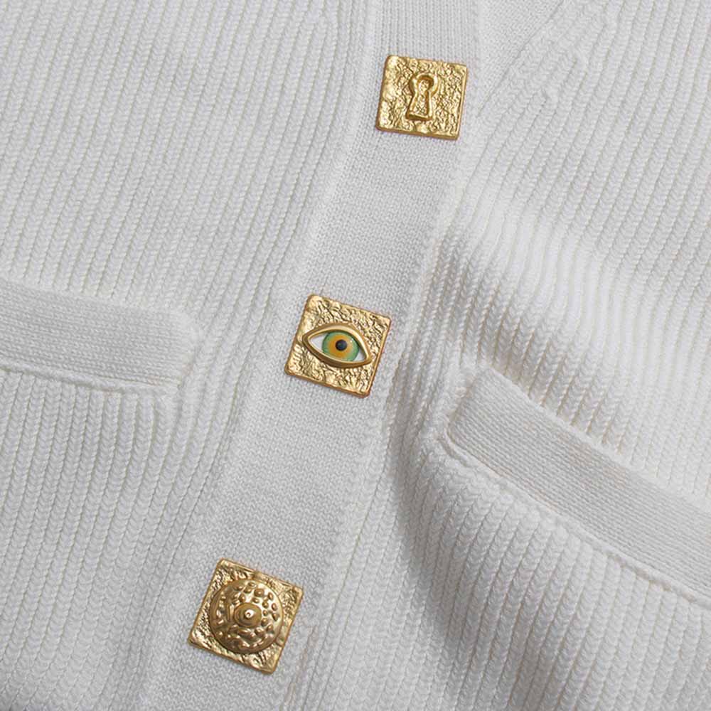 White women's v neck knitted cardigan featuring unique gold decorative buttons