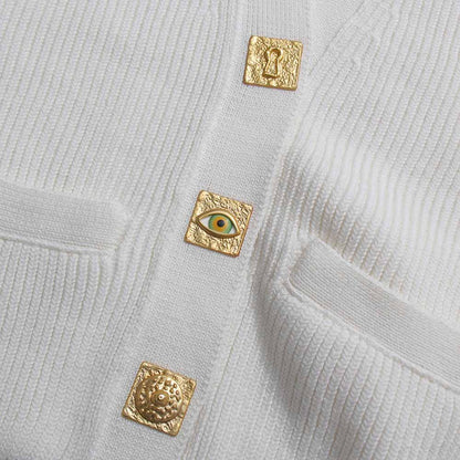 White women's v neck knitted cardigan featuring unique gold decorative buttons