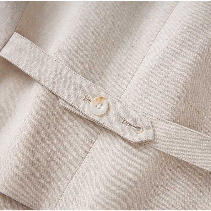 Close-up of the button detail on a women's vest pantsuit set in beige fabric by SD Dresscode & Fashiontrends