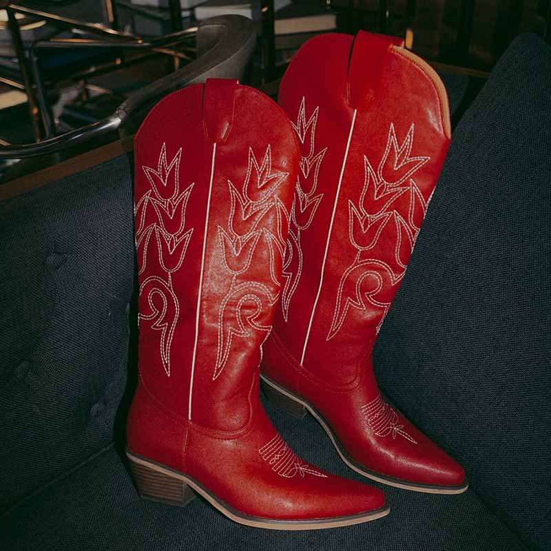 Red women's western embroidered boots with unique stitching and pointed toe design