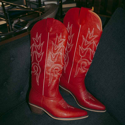 Red women's western embroidered boots with unique stitching and pointed toe design