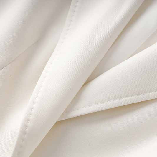 Close-up of women's white pantsuit set showcasing soft fabric and tailored details