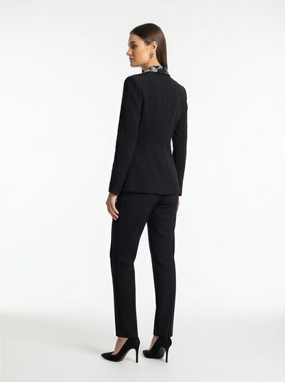 Woman wearing a black suit on a white background