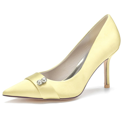 Yellow high-heeled shoe with a decorative bow on a white background