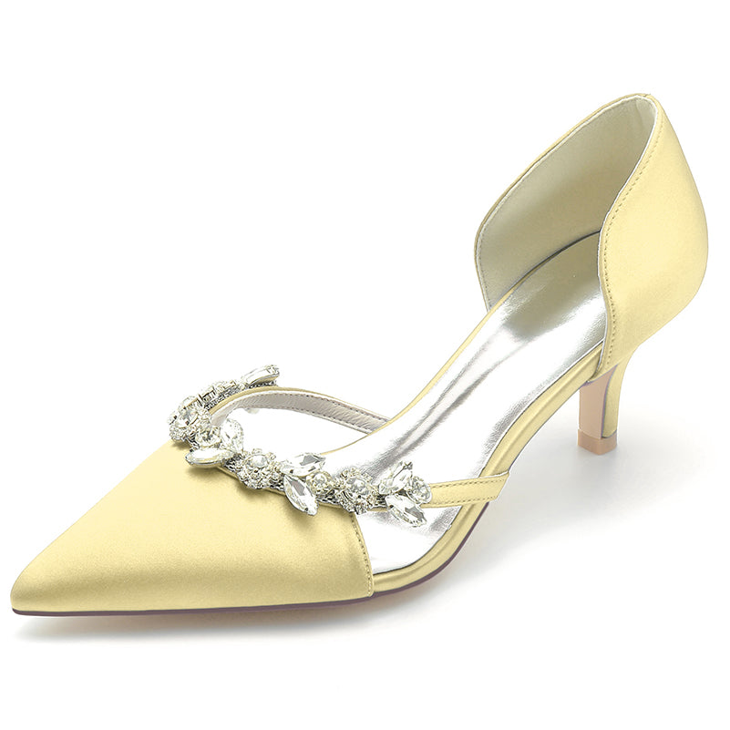 Gold high-heeled shoe with decorative strap on a white background