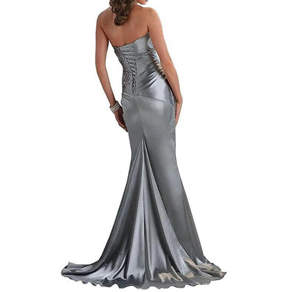 Back view of a silver beaded mermaid evening dress with a strapless design and flowing skirt