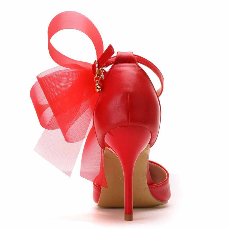 Red bridal closed toe high heel sandals with a decorative bow at the heel for elegant weddings
